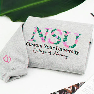 Custom sport gray floral sweatshirt personalized with university and College of Nursing wording