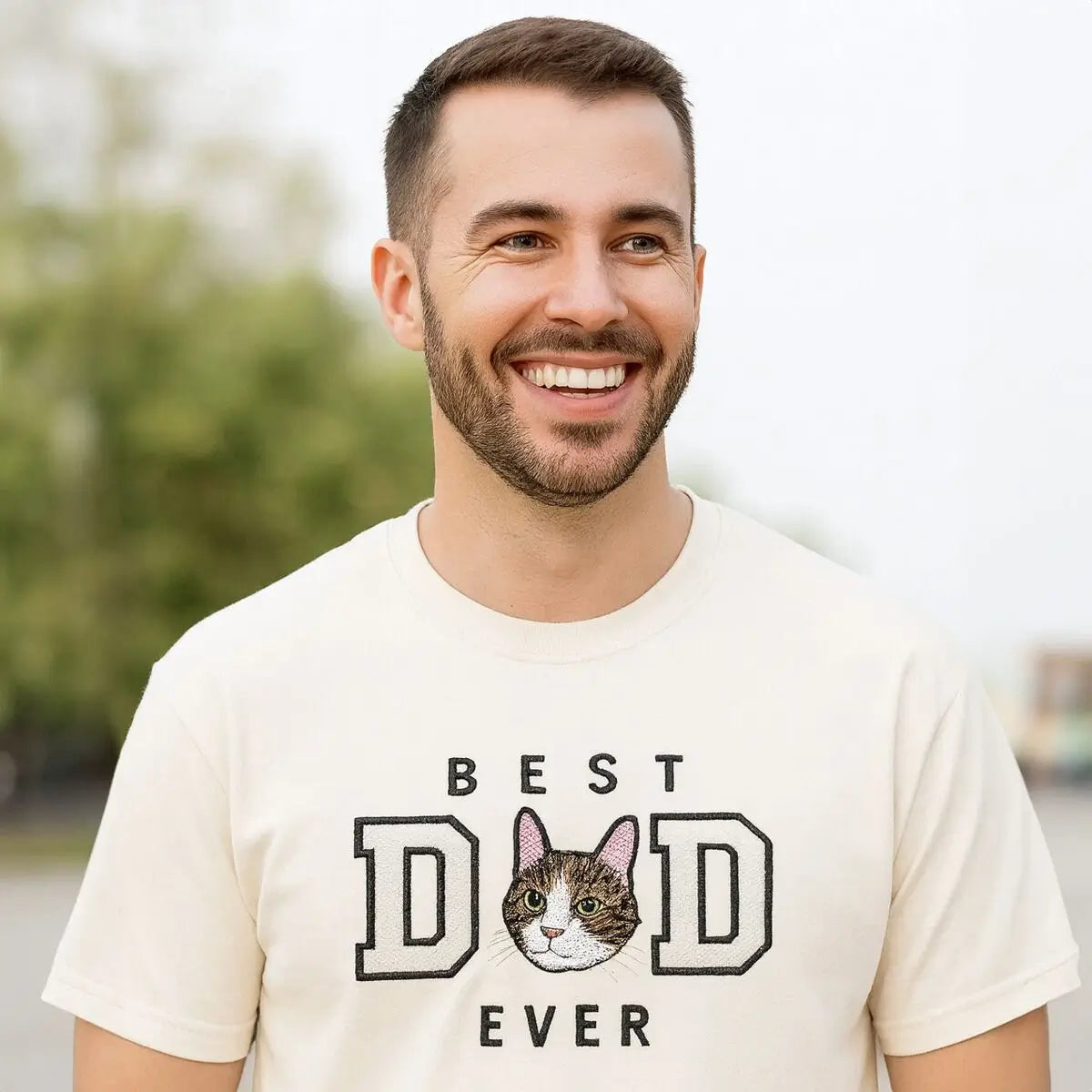 Embroidered custom cat dad shirt featuring personalized portrait of cat on fabric, worn by a smiling man
