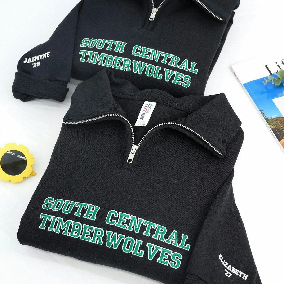 Black quarter-zip with personalized green South Central Timberwolves chest embroidery and a custom name and year on the sleeve.