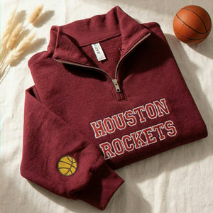 Maroon cadet-collar quarter-zip featuring retro college name chest embroidery and a stitched game day icon sleeve patch.