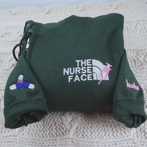 Custom embroidered quarter zip sweatshirt with nurse face design and personalized sleeve text"