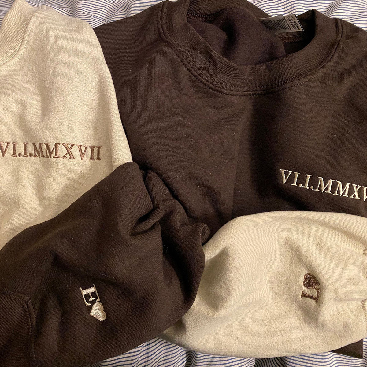 Cream and brown sweatshirts embroidered with a Roman numeral wedding date, cuffs monogrammed with heart initials