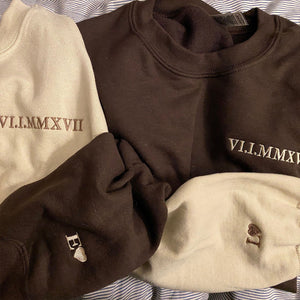 Cream and brown sweatshirts embroidered with a Roman numeral wedding date, cuffs monogrammed with heart initials