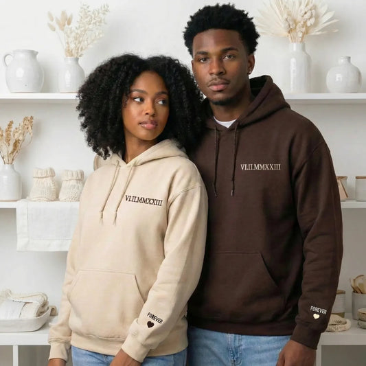 Couple wearing matching roman numeral hoodies