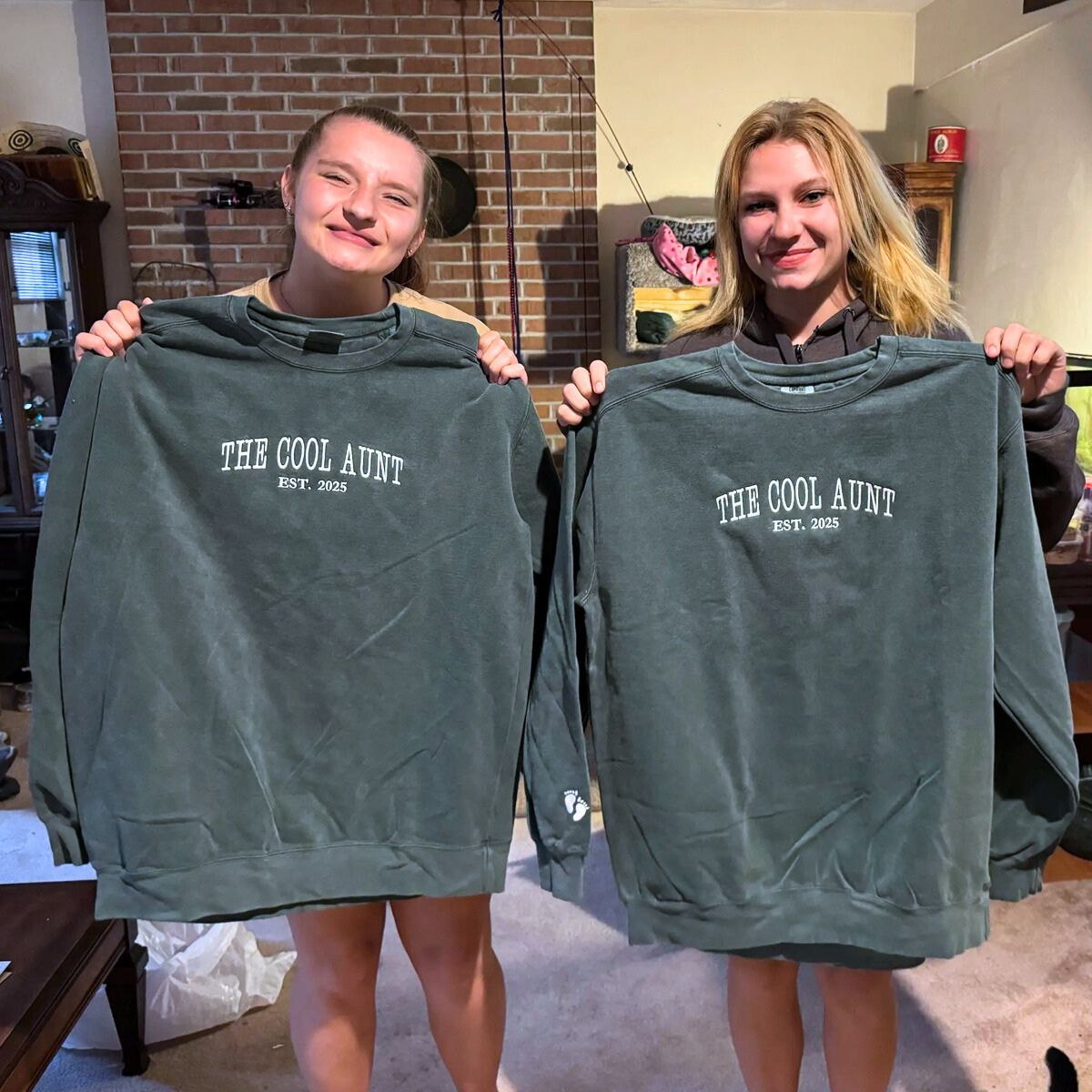 Two women holding dark green 