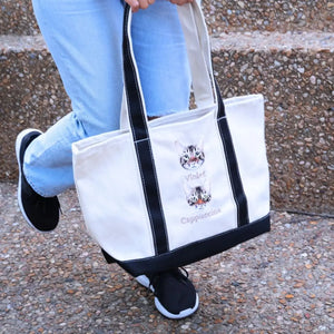 Cat-themed gift set including sweatshirt, tote bag, and hat displayed on a cozy background