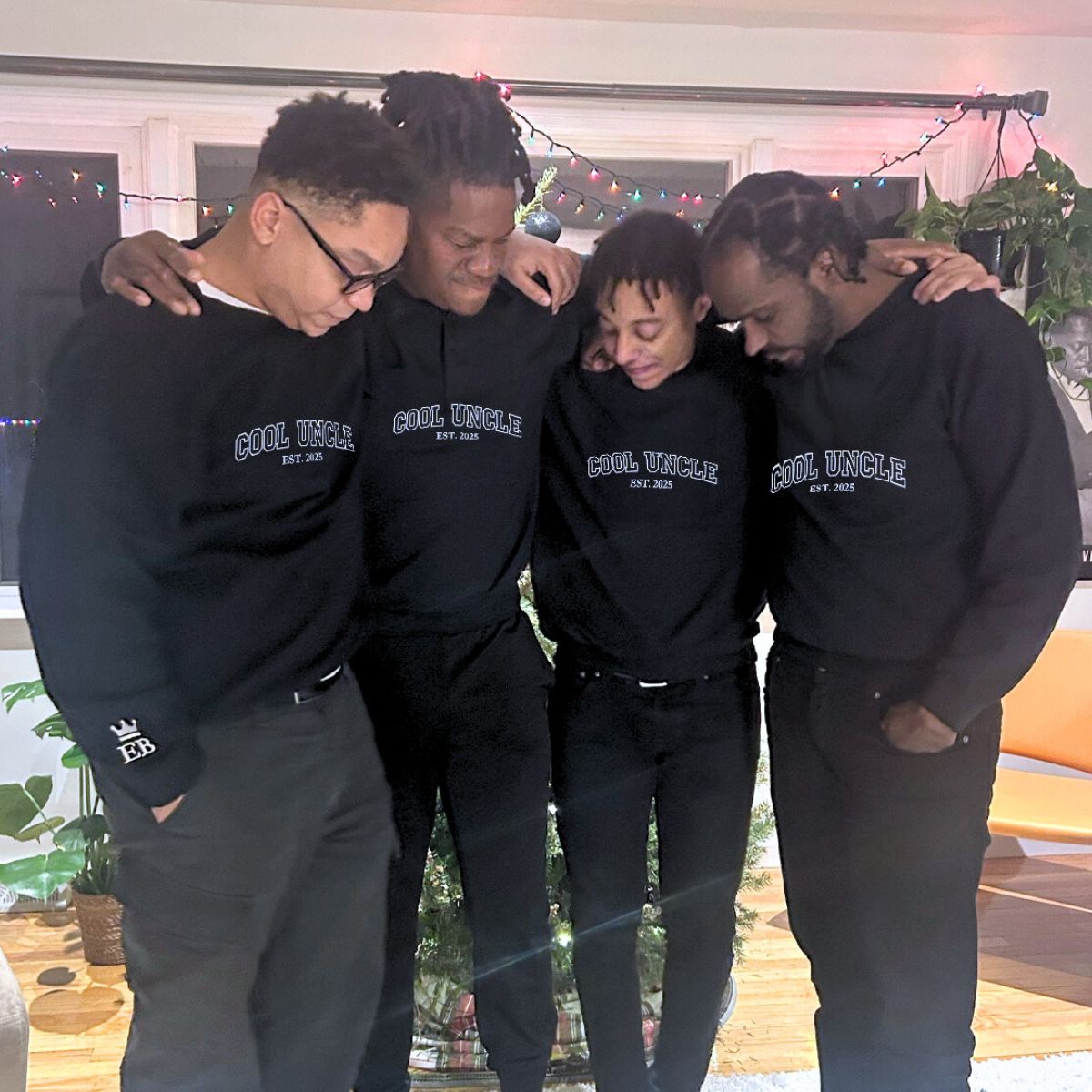 A group of four wearing matching black 'Cool Uncle' embroidered sweatshirts, perfect for family bonding.