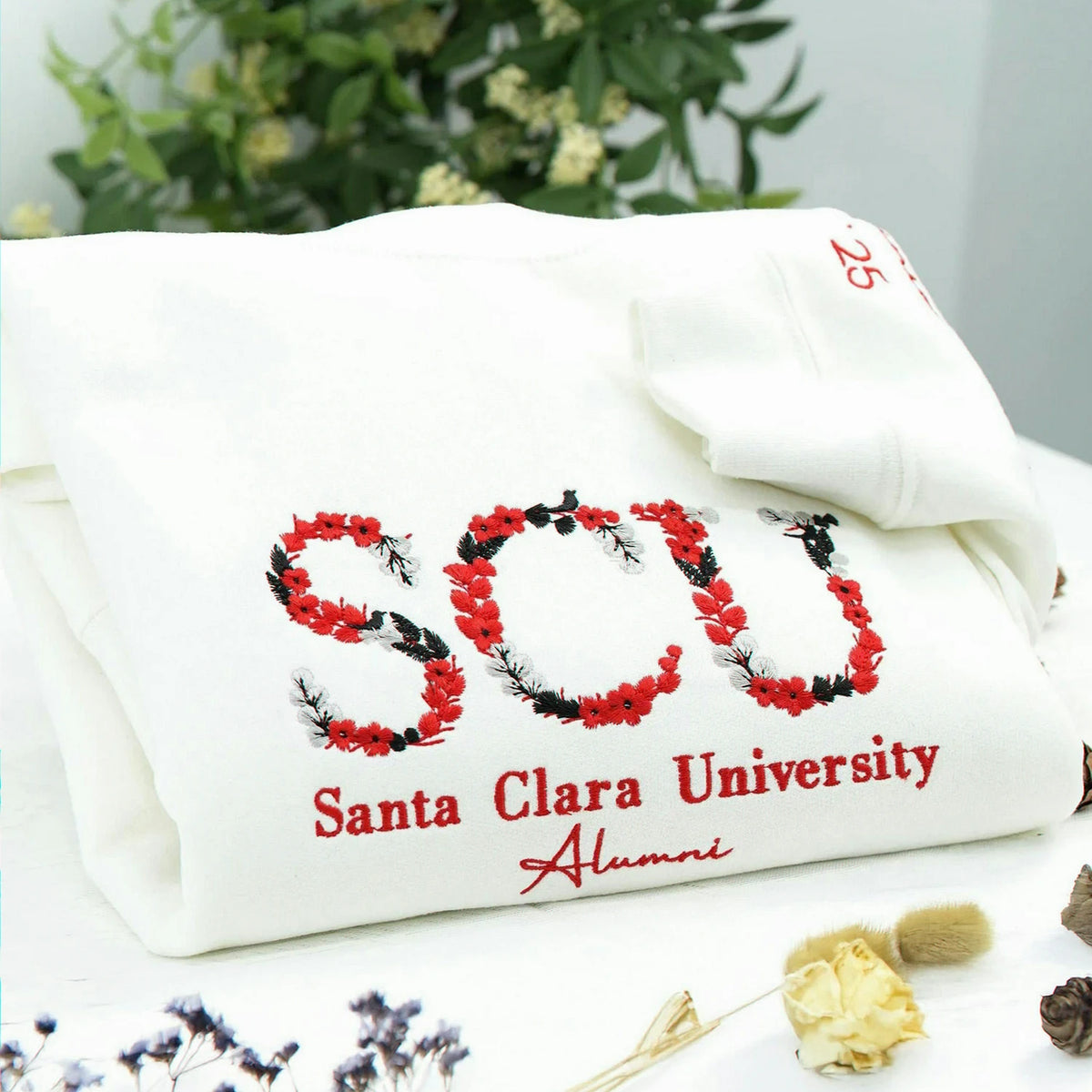 A white soft college spirit sweatshirt with floral embroidery, made for graduation photos, alumni memories, sorority moments, and everyday campus pride