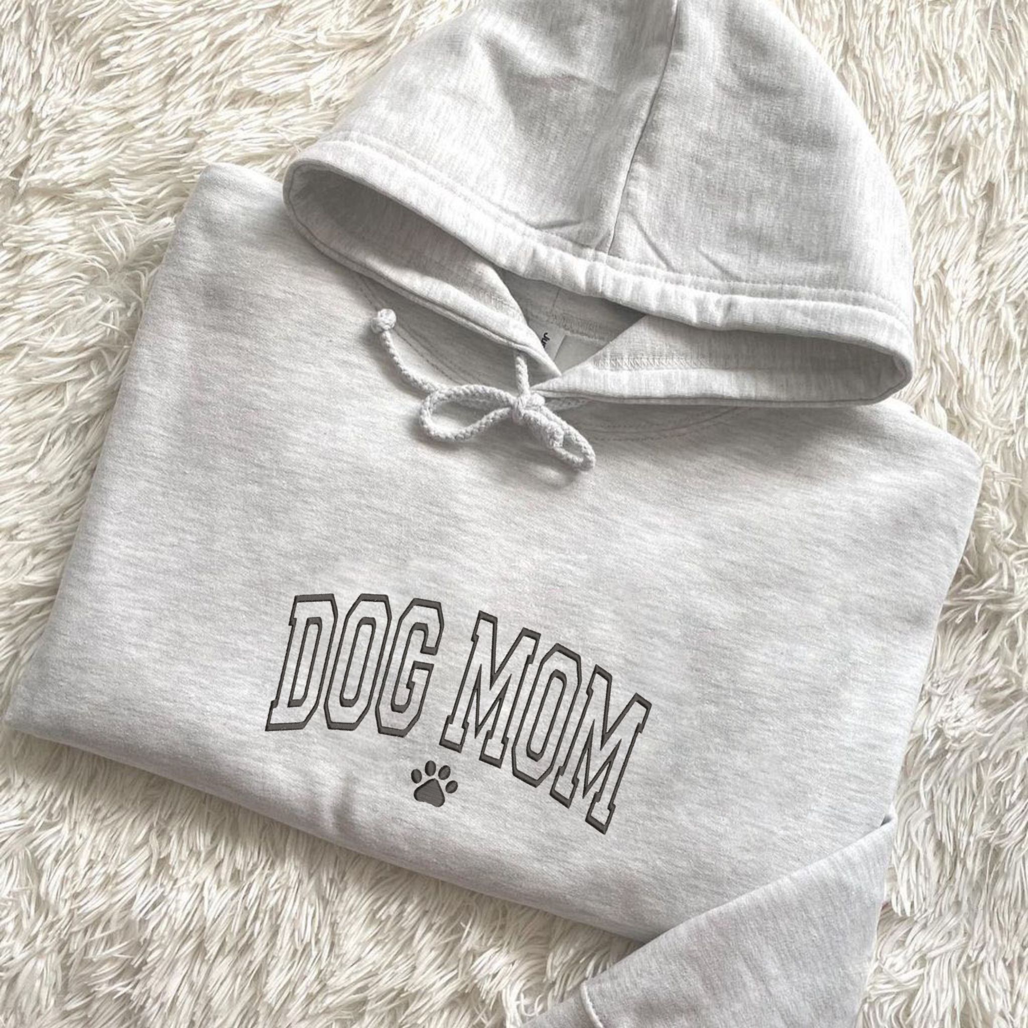 https://embroly.com/cdn/shop/products/custom-embroidered-dog-mom-hoodie-personalized-hoodie-with-icon-gift-for-dog-lovers_5000x.jpg?v=1680928204
